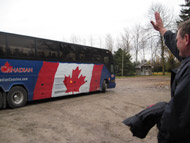A tour bus with a Canadian flag, and a man waving